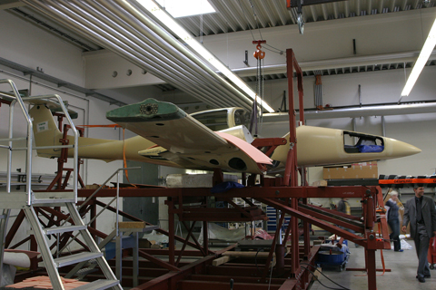 It all begins here. Composite materials like fiberglass (green) and carbon fibre (black) are moulded, shaped and impregnated separately before being put together into their final shape, as seen here. After this is complete, the aircraft will be disassembled again for painting and systems installation