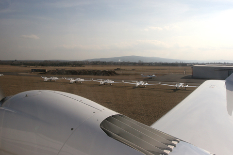 Lifting off Wiener Neustadt's 1,067 m runway 10 to the sight of six brand new, factory fresh Twin Stars waiting outside after assembly. The big grille you see on the nacelle is the coolant system radiatior - being originally a car engine, the Centurion is water cooled.