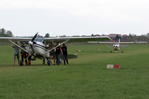You up front, move it! Taxiway hogs... :). A cheerful group of skydivers pushing their plane back to the hangar all the way from the RWY 10 threshold - more than a kilometer away.