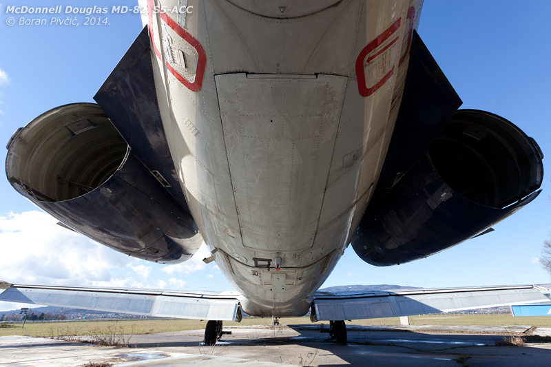 The party piece of the DC-9/MD-80 design, the rear air stairs were designed as a cheap and simple way of speeding up boarding without having to rely on your destination's (sometimes questionable) ground equipment. However, after two well known incidents in the 70s - one on the DC-9 and one on the 727 - where hijackers parachuted out through this door, it was disabled and locked on most in-service machines (interestingly, the world-renowned Perris Valley Skydive center used to fly a short-body DC-9-21 on parachute flights). A good thing too, since my ears still have childhood traumas from the wail of the APU - located next to the right nacelle - while boarding JAT's DC-9s in the late 80s... note also the protective tail skid just below the door, preventing tail scrapes on rotation.